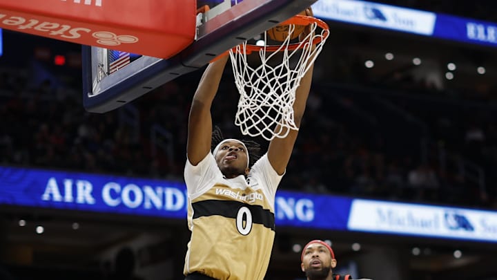 Dec 26, 2025; Washington, District of Columbia, USA; Washington Wizards guard Bilal Coulibaly (0) dunks the ball as Toronto Raptors forward Brandon Ingram (3) looks on in the second half at Capital One Arena. Mandatory Credit: Geoff Burke-Imagn Images