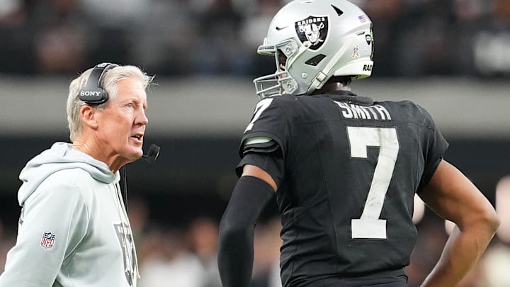 Nov 23, 2025; Paradise, Nevada, USA; Las Vegas Raiders quarterback Geno Smith (7) talks to head coach Pete Carroll in game against the Cleveland Browns during the fourth quarter at Allegiant Stadium. Mandatory Credit: Stephen R. Sylvanie-Imagn Images