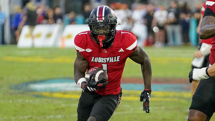 Dec 23, 2025; Boca Raton, FL, USA; Louisville Cardinals running back Isaac Brown (1) rushes for a first down during the fourth quarter of the Boca Raton Bowl at Flagler CU Stadium. Mandatory Credit: Jeff Romance-Imagn Images