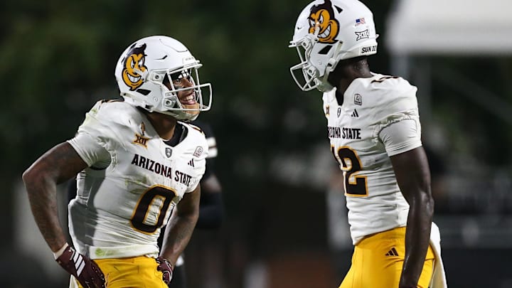 Sep 6, 2025; Starkville, Mississippi, USA; Arizona State Sun Devils wide receiver Jordyn Tyson (0) and wide receiver Malik McClain (12) react after a catch during the fourth quarter against the Mississippi State Bulldogs at Davis Wade Stadium at Scott Field. Mandatory Credit: Petre Thomas-Imagn Images