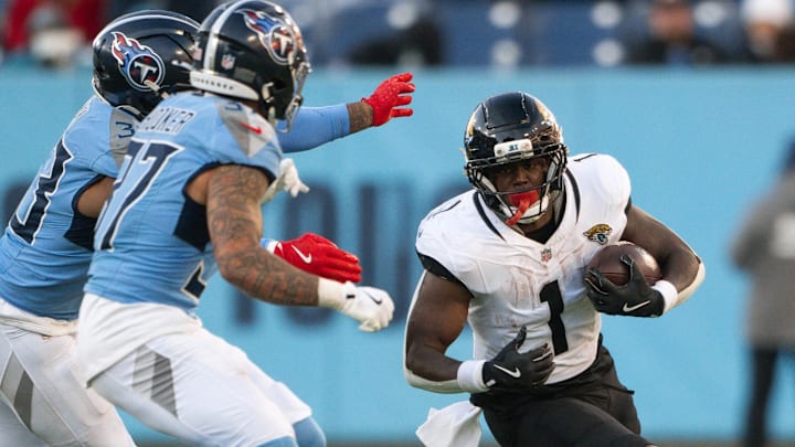 Nov 30, 2025; Nashville, Tennessee, USA;  Jacksonville Jaguars running back Travis Etienne Jr. (1) runs with the ball against the Tennessee Titans during the second half at Nissan Stadium. Mandatory Credit: Steve Roberts-Imagn Images