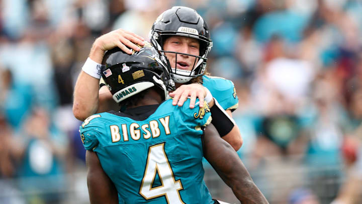Oct 6, 2024; Jacksonville, Florida, USA; Jacksonville Jaguars running back Tank Bigsby (4) celebrates with quarterback Trevor Lawrence (16) after scoring a touchdown against the Indianapolis Colts in the fourth quarter at EverBank Stadium. Mandatory Credit: Nathan Ray Seebeck-Imagn Images