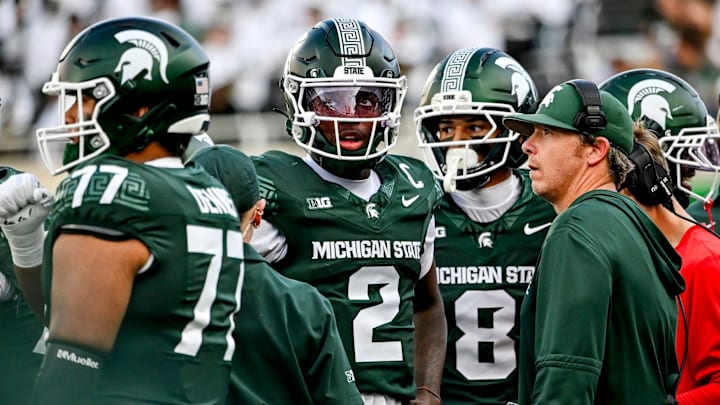 Michigan State's Aidan Chiles, left, and quarterbacks coach Jon Boyer meet on the sideline during the fourth quarter in the game against Youngstown State on Saturday, Sept. 13, 2025, at Spartan Stadium in East Lansing.