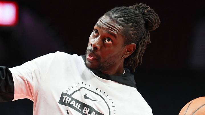 Jan 11, 2026; Portland, Oregon, USA; Portland Trail Blazers guard Jrue Holiday (5) reacts while taking a one-handed shot during warm ups before playing against the New York Knicks at Moda Center. Mandatory Credit: Jaime Valdez-Imagn Images