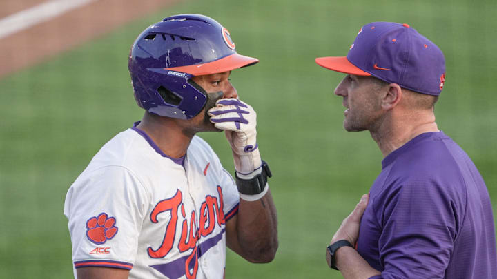 Clemson sophomore Jarren Purify (23) covers his mouth talking to Clemson Head Coach Erik Bakich during the bottom of the eighth inning at Doug Kingsmore Stadium in Clemson, S.C. Sunday, March 1, 2026.