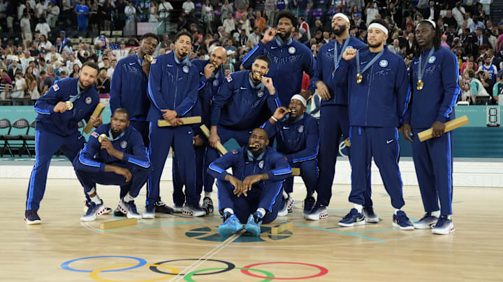 Aug 10, 2024; Paris, France; Team USA celebrates with the gold medal after the game against France in the men's basketball gold medal game during the Paris 2024 Olympic Summer Games at Accor Arena. Mandatory Credit: Kyle Terada-Imagn Images