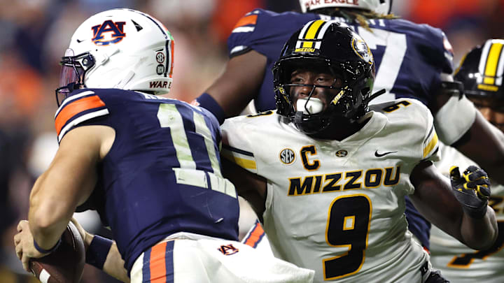 Oct 18, 2025; Auburn, Alabama, USA;  Missouri Tigers defensive end Zion Young (9) moves in to tackle Auburn Tigers quarterback Jackson Arnold (11) during the fourth quarter at Jordan-Hare Stadium.  Mandatory Credit: John Reed-Imagn Images