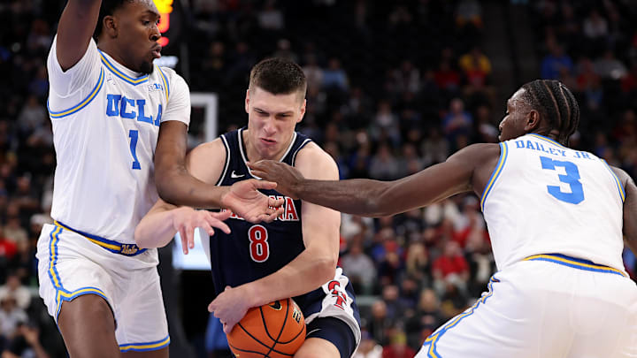 Nov 14, 2025; Inglewood, California, USA; Arizona Wildcats forward Ivan Kharchenkov (8) drives between UCLA Bruins center Xavier Booker (1) and forward Eric Dailey Jr. (3) during the first half of the Hall of Fame Series game at Intuit Dome. Mandatory Credit: Kiyoshi Mio-Imagn Images Nov 14, 2025; Inglewood, California, USA; Arizona Wildcats forward Ivan Kharchenkov (8) drives between UCLA Bruins center Xavier Booker (1) and forward Eric Dailey Jr. (3) during the first half of the Hall of Fame Series game at Intuit Dome. Mandatory Credit: Kiyoshi Mio-Imagn Images