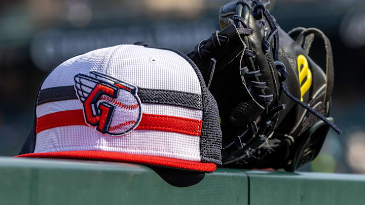Jul 8, 2024; Detroit, Michigan, USA; A Cleveland Guardians baseball cap and glove sit on the dugout rail before the game against the Detroit Tigers at Comerica Park. Mandatory Credit: David Reginek-Imagn Images