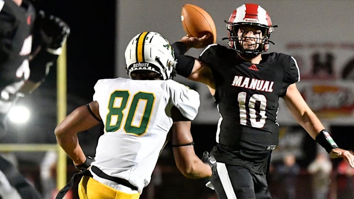 Manual's Elijah Creech (10) attempts a pass oner the defense of St. Xavier's Karsten Busch (80) during the first half of their game, Friday, Oct. 6, 2023 in Louisville, Ky.