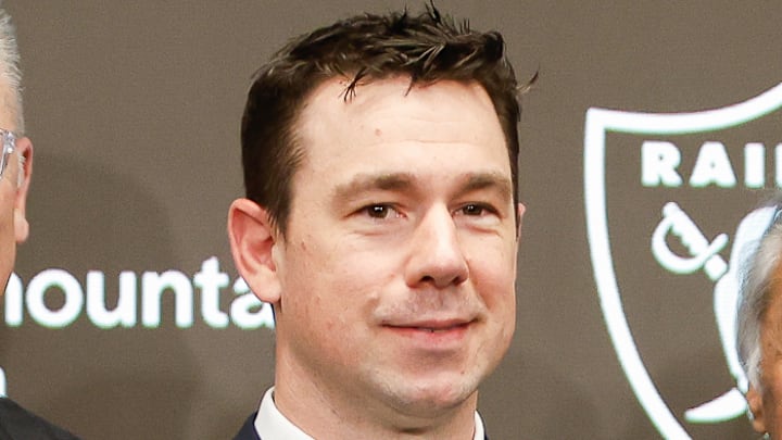 Coach Klint Kubiak and GM John Spytek flanked by multiple NFL, Raider greats.