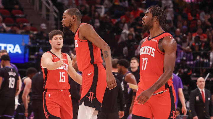 Feb 23, 2026; Houston, Texas, USA;  Houston Rockets guard Reed Sheppard (15) celebrates forward Kevin Durant (7) and forward Tari Eason (17) play against the Utah Jazz in the second quarter at Toyota Center. Mandatory Credit: Thomas Shea-Imagn Images