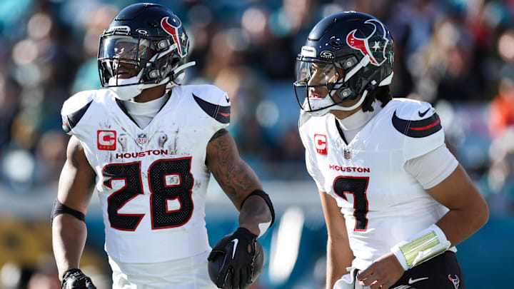 Dec 1, 2024; Jacksonville, Florida, USA; Houston Texans running back Joe Mixon (28) celebrates with quarterback C.J. Stroud (7) after scoring a touchdown  against the Jacksonville Jaguars in the third quarter at EverBank Stadium. Mandatory Credit: Nathan Ray Seebeck-Imagn Images