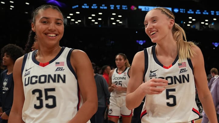 Dec 7, 2024; Brooklyn, New York, USA; Connecticut Huskies guard Azzi Fudd (35) and Connecticut Huskies guard Paige Bueckers (5) celebrate after the game against the Louisville Cardinals at Barclays Center. Mandatory Credit: Lucas Boland-Imagn Images