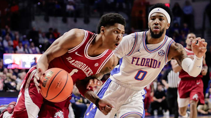 Arkansas Razorbacks guard Meleek Thomas (1) drives to the basket against Florida Gators guard Boogie Fland (0) during the first half at Exactech Arena at the Stephen C. O'Connell Center. 