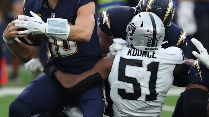 Nov 30, 2025; Inglewood, California, USA; Las Vegas Raiders defensive end Malcolm Koonce (51) sacks Los Angeles Chargers quarterback Justin Herbert (10) during the second half at SoFi Stadium. Mandatory Credit: Kiyoshi Mio-Imagn Images