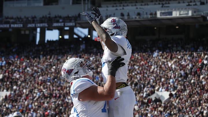 Mississippi Rebels offensive lineman Patrick Kutas (75) and wide receiver Harrison Wallace III (2) celebrate after a touchdown in the first half against the Mississippi State Bulldogs at Davis Wade Stadium at Scott Field. 