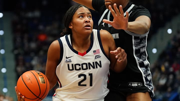 Dec 15, 2024; Storrs, Connecticut, USA; UConn Huskies forward Sarah Strong (21) drives the ball against Georgetown Hoyas center Ariel Jenkins (21) in the first half at XL Center. Mandatory Credit: David Butler II-Imagn Images