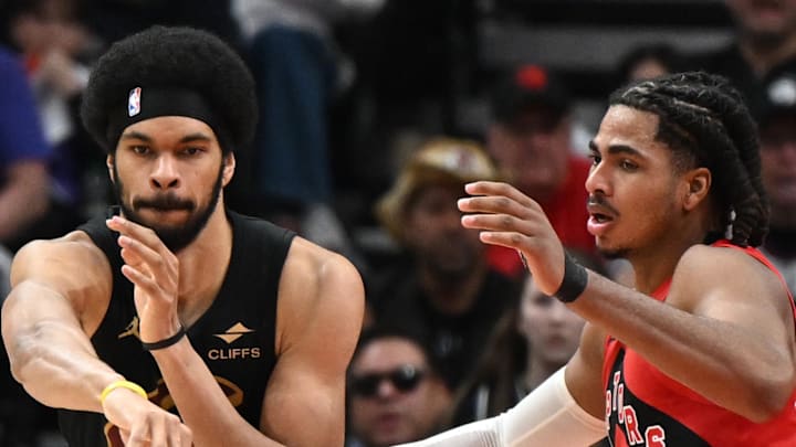 Cleveland Cavaliers center Jarrett Allen passes the ball as Toronto Raptors forward Collin Murray-Boyles defends.