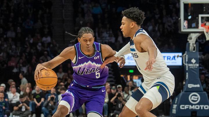 Mar 18, 2026; Minneapolis, Minnesota, USA; Utah Jazz forward Cody Williams (5) dribbles the ball as Minnesota Timberwolves guard Terrence Shannon Jr. (1) plays defense in the second half at Target Center. Mandatory Credit: Jesse Johnson-Imagn Images