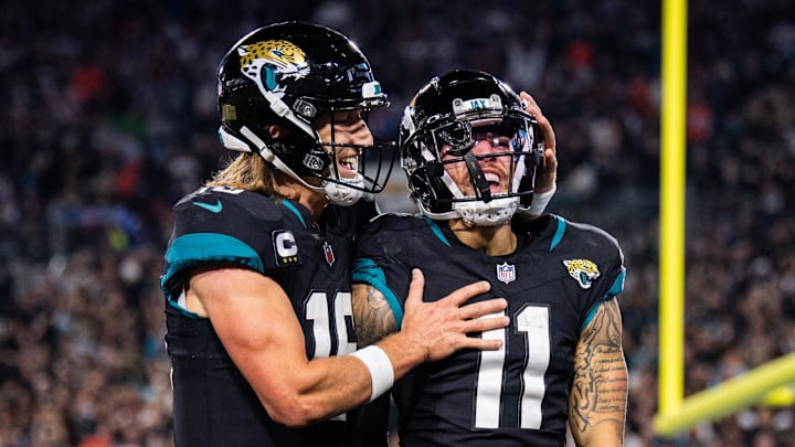 Dec 4, 2023; Jacksonville, Florida, USA; Jacksonville Jaguars wide receiver Parker Washington (11) and quarterback Trevor Lawrence (16) celebrates his touchdown against the Cincinnati Bengals in the third quarter at EverBank Stadium. Mandatory Credit: Jeremy Reper-Imagn Images
