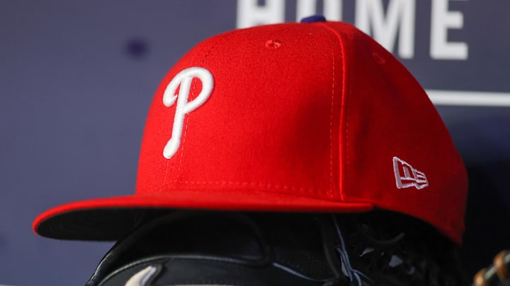 May 26, 2023; Atlanta, Georgia, USA; A detailed view of a Philadelphia Phillies hat and glove on the bench against the Atlanta Braves in the seventh inning at Truist Park. 
