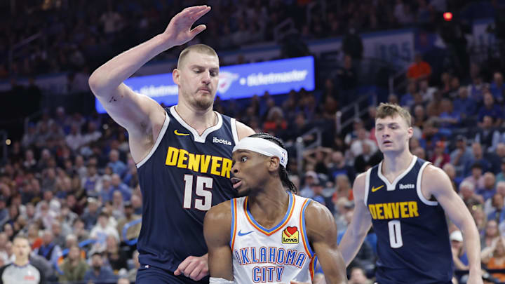 Mar 10, 2025; Oklahoma City, Oklahoma, USA; Denver Nuggets center Nikola Jokic (15) defends a drive by Oklahoma City Thunder guard Shai Gilgeous-Alexander (2) during the second half at Paycom Center. Mandatory Credit: Alonzo Adams-Imagn Images Mar 10, 2025; Oklahoma City, Oklahoma, USA; Denver Nuggets center Nikola Jokic (15) defends a drive by Oklahoma City Thunder guard Shai Gilgeous-Alexander (2) during the second half at Paycom Center. Mandatory Credit: Alonzo Adams-Imagn Images