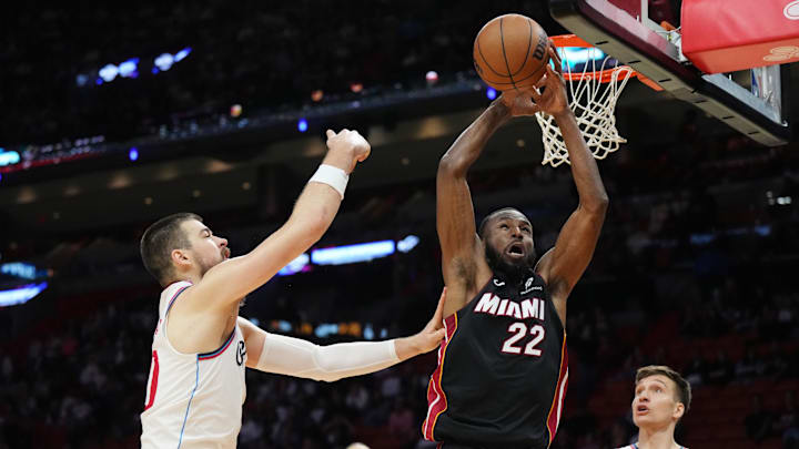 Mar 12, 2025; Miami, Florida, USA;  Miami Heat forward Andrew Wiggins (22) fumbles the pass as LA Clippers center Ivica Zubac (40) closes in during the second half at Kaseya Center. Mandatory Credit: Jim Rassol-Imagn Images