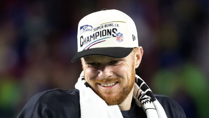 Seattle Seahawks quarterback Sam Darnold celebrates on the podium after defeating the New England Patriots.