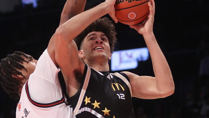 Apr 1, 2025; Brooklyn, NY, USA; McDonald's All American East forward Cameron Boozer (12) shoots the ball against McDonald's All American West center Chris Cenac Jr. (1) during the second half of the game at Barclays Center. Mandatory Credit: Pamela Smith-Imagn Images