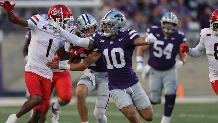 Kansas State Wildcats wide receiver Keagan Johnson (10) blocks Arizona Wildcats defensive back Tacario Davis (1) from reaching Kansas State Wildcats quarterback Avery Johnson (2) during the first quarter of the game at Bill Snyder Family Stadium Friday, September 13, 2024.
