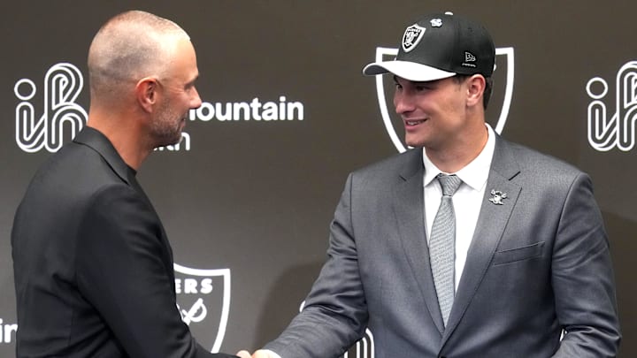 Apr 24, 2026; Henderson, NV, USA; Las Vegas Raiders quarterback Fernando Mendoza (right) shakes hands with general manager John Spytek at introductory press conference at Intermountain Health Performance Center after being selected as the No. 1 pick in the 2026 NFL Draft. Mandatory Credit: Kirby Lee-Imagn Images