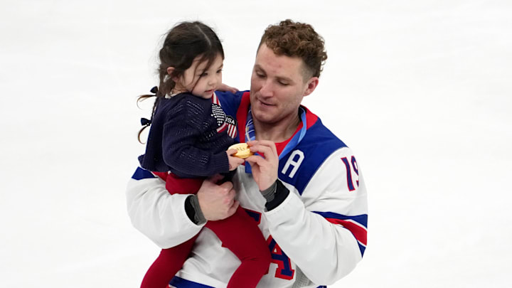 Feb 22, 2026; Milan, Italy; Matthew Tkachuk of the United States celebrates while holding Noa Gaudreau, the daughter of the late Johnny Gaudreau after winning the men's ice hockey gold medal game during the Milano Cortina 2026 Olympic Winter Games at Milano Santagiulia Ice Hockey Arena. Mandatory Credit: James Lang-Imagn Images Feb 22, 2026; Milan, Italy; Matthew Tkachuk of the United States celebrates while holding Noa Gaudreau, the daughter of the late Johnny Gaudreau after winning the men's ice hockey gold medal game during the Milano Cortina 2026 Olympic Winter Games at Milano Santagiulia Ice Hockey Arena. Mandatory Credit: James Lang-Imagn Images