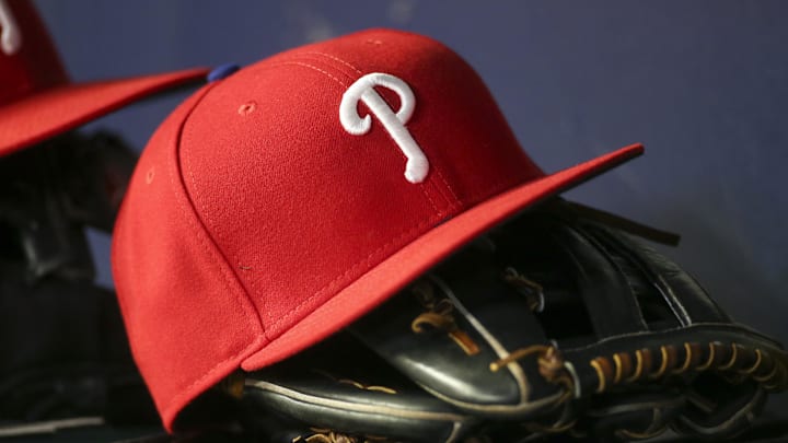 Detailed view of a Philadelphia Phillies hat and glove in the dugout | Brett Davis-USA TODAY Sports