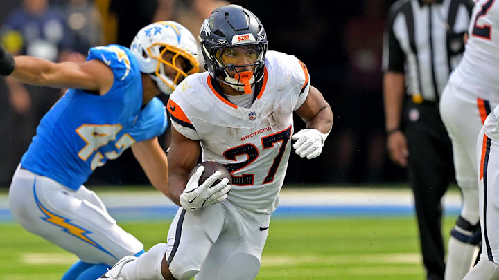 Sep 21, 2025; Inglewood, California, USA;   Denver Broncos running back J.K. Dobbins (27) carries the ball in the second half against the Los Angeles Chargers at SoFi Stadium. 