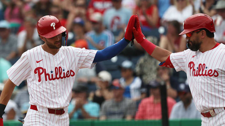 Mar 24, 2025; Clearwater, Florida, USA; Philadelphia Phillies shortstop Trea Turner (7) is congratulated by designated hitter Kyle Schwarber (12) as he scores a run during the first inning against the Tampa Bay Rays  at BayCare Ballpark.