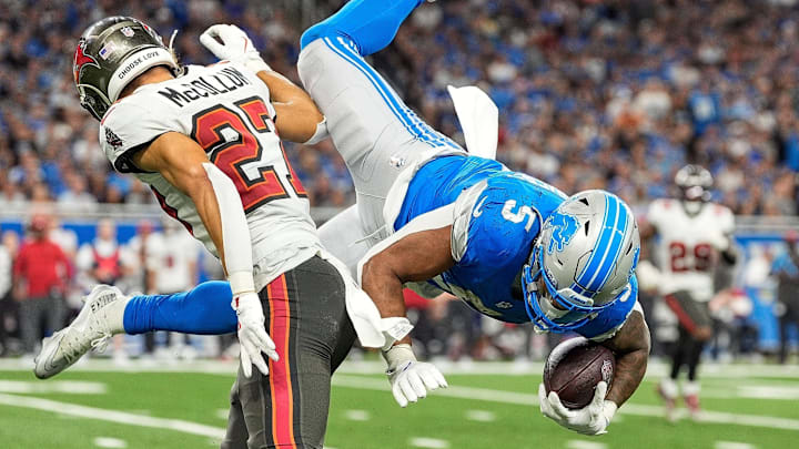 Former Detroit Lions running back David Montgomery (5) jumps over Tampa Bay Buccaneers cornerback Zyon McCollum (27) Former Detroit Lions running back David Montgomery (5) jumps over Tampa Bay Buccaneers cornerback Zyon McCollum (27)