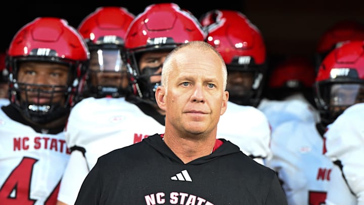 Sep 11, 2025; Winston-Salem, North Carolina, USA; North Carolina State Wolfpack head coach Dave Doeren walks his team out on the field against the Wake Forest Demon Deacons at Allegacy Federal Credit Union Stadium. Mandatory Credit: Luke Jamroz-Imagn Images Sep 11, 2025; Winston-Salem, North Carolina, USA; North Carolina State Wolfpack head coach Dave Doeren walks his team out on the field against the Wake Forest Demon Deacons at Allegacy Federal Credit Union Stadium. Mandatory Credit: Luke Jamroz-Imagn Images