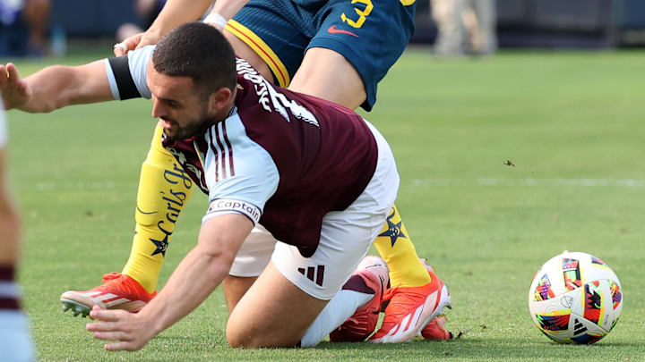 Aug 3, 2024; Chicago, Illinois, USA; Club America defender Israel Reyes (3) slide tackles Aston Villa midfielder John McGinn (7) during the first half at Soldier Field. Mandatory Credit: Mike Dinovo-Imagn Images