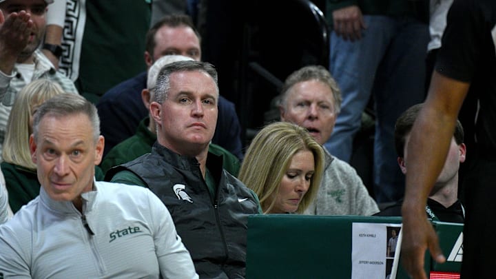 Dec 2, 2025; East Lansing, Michigan, USA; Michigan State head football coach Pat Fitzgerald watches the Spartans defeat the Iowa Hawkeyes at Jack Breslin Student Events Center. Mandatory Credit: Dale Young-Imagn Images Dec 2, 2025; East Lansing, Michigan, USA; Michigan State head football coach Pat Fitzgerald watches the Spartans defeat the Iowa Hawkeyes at Jack Breslin Student Events Center. Mandatory Credit: Dale Young-Imagn Images
