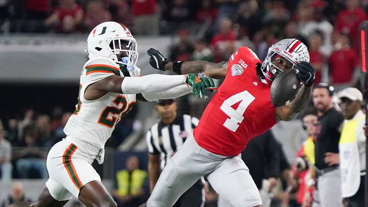 Dec 31, 2025; Arlington, TX, USA; Ohio State Buckeyes wide receiver Jeremiah Smith (4) misses a pass while defended by Miami Hurricanes defensive back OJ Frederique Jr. (29) in the second quarter during the 2025 Cotton Bowl and quarterfinal game of the College Football Playoff at AT&T Stadium. Mandatory Credit: Raymond Carlin III-Imagn Images Dec 31, 2025; Arlington, TX, USA; Ohio State Buckeyes wide receiver Jeremiah Smith (4) misses a pass while defended by Miami Hurricanes defensive back OJ Frederique Jr. (29) in the second quarter during the 2025 Cotton Bowl and quarterfinal game of the College Football Playoff at AT&T Stadium. Mandatory Credit: Raymond Carlin III-Imagn Images