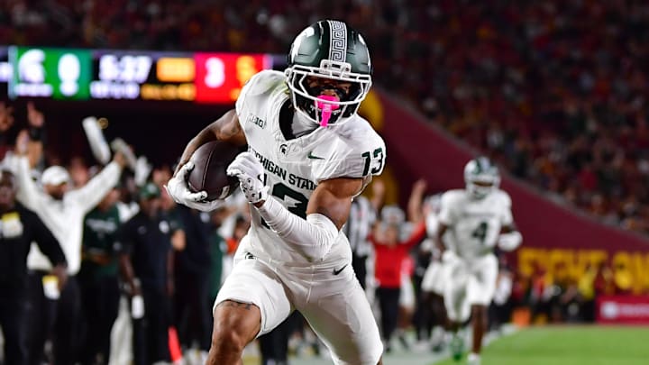 Sep 20, 2025; Los Angeles, California, USA; Michigan State Spartans wide receiver Chrishon McCray (13) scores a touchdown against the against the Southern California Trojans during the first half at the Los Angeles Memorial Coliseum. Mandatory Credit: Gary A. Vasquez-Imagn Images