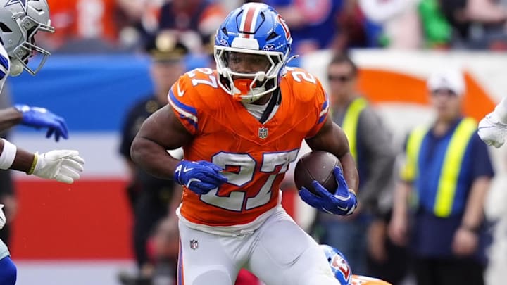 Oct 26, 2025; Denver, Colorado, USA; Denver Broncos running back J.K. Dobbins (27) runs against the Dallas Cowboys in the first half at Empower Field at Mile High. Mandatory Credit: Ron Chenoy-Imagn Images