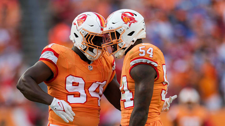 Tampa Bay Buccaneers linebacker Lavonte David celebrates with defensive tackle Calijah Kancey.