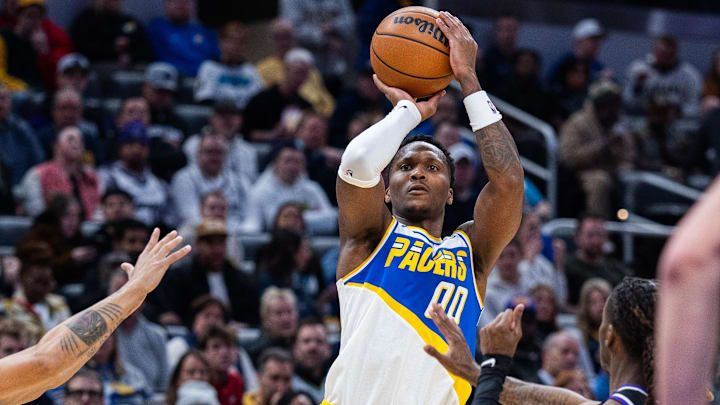 Dec 8, 2025; Indianapolis, Indiana, USA; Indiana Pacers guard Bennedict Mathurin (00) shoots the ball while  Sacramento Kings guard Malik Monk (0) defends in the first half at Gainbridge Fieldhouse. Mandatory Credit: Trevor Ruszkowski-Imagn Images