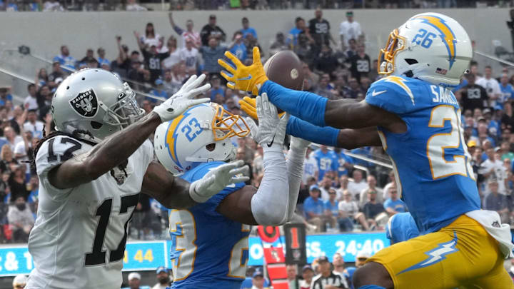 Sep 11, 2022; Inglewood, California, USA; Los Angeles Chargers cornerback Asante Samuel Jr. (26) intercepts a pass intended for Las Vegas Raiders wide receiver Davante Adams (17) in the second half at SoFi Stadium. Mandatory Credit: Kirby Lee-Imagn Images