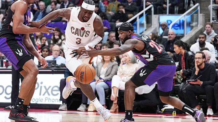 Oct 23, 2024; Toronto, Ontario, CAN; Cleveland Cavaliers guard Caris LeVert (3) drives to the basket between Toronto Raptors forward Scottie Barnes (4) and guard Jamal Shead (23) during the third quarter at Scotiabank Arena. Mandatory Credit: Nick Turchiaro-Imagn Images Oct 23, 2024; Toronto, Ontario, CAN; Cleveland Cavaliers guard Caris LeVert (3) drives to the basket between Toronto Raptors forward Scottie Barnes (4) and guard Jamal Shead (23) during the third quarter at Scotiabank Arena. Mandatory Credit: Nick Turchiaro-Imagn Images