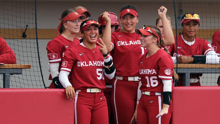 Oklahoma seniors Ailana Agbayani (left), Isabela Emerling (center) and Abby Dayton (right) celebrate a Gabbie Garcia hit in the dugout at Love's Field. Oklahoma seniors Ailana Agbayani (left), Isabela Emerling (center) and Abby Dayton (right) celebrate a Gabbie Garcia hit in the dugout at Love's Field.