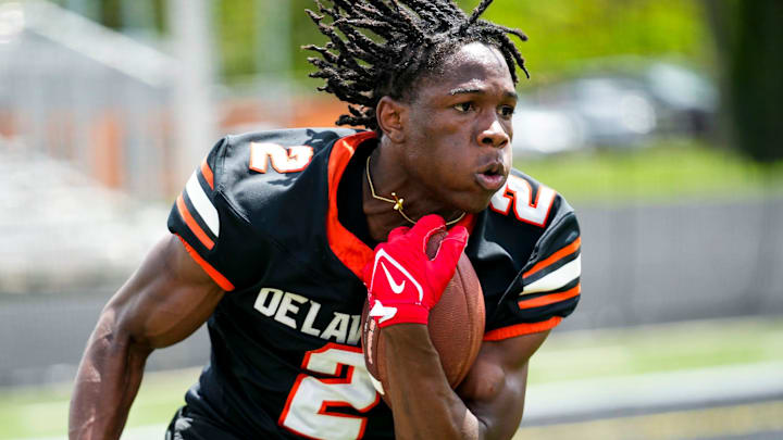 Delaware Hayes’s Favour Akih (2) runs the ball during the college football showcase at the Delaware Hayes High School on Wednesday, May 7, 2025 in Delaware, Ohio.