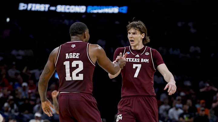 Texas A&M Aggies forward Rashaun Agee (12) celebrates with Texas A&M Aggies forward Zach Clemence (7) during a first round game of the men's 2026 NCAA Tournament at Paycom Center. 